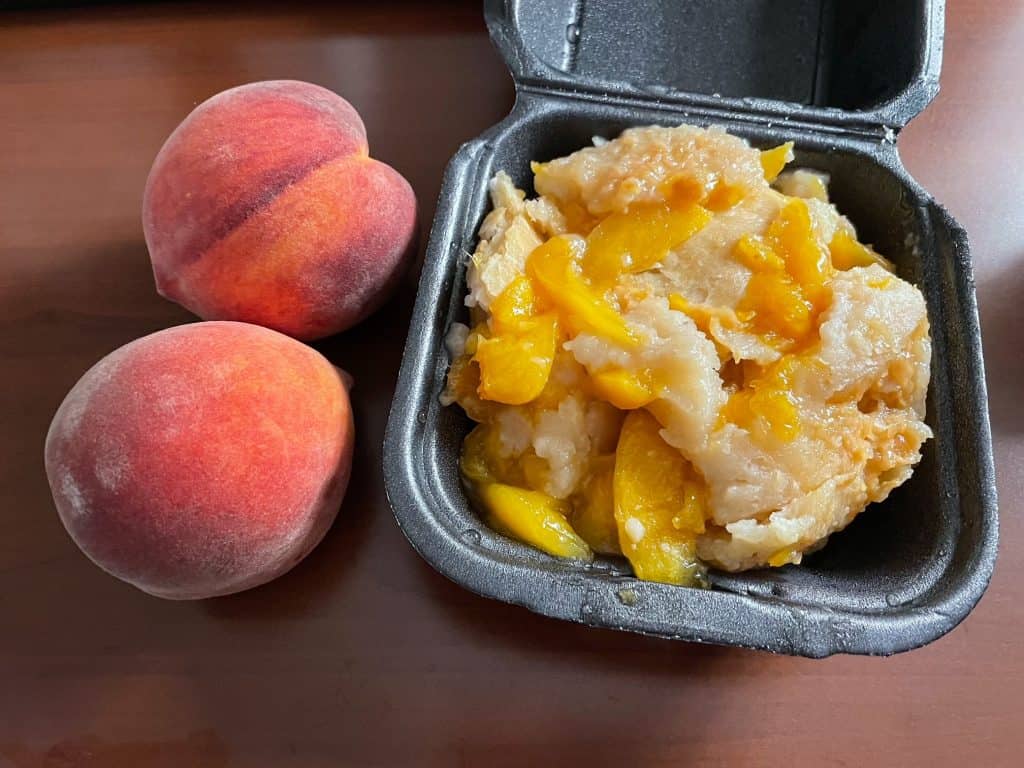 Two fresh sweet peaches and the best peach cobbler.