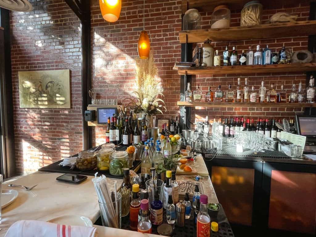 Eating at the bar at Ovenbird restaurant that has an upscale yet casual ambiance.