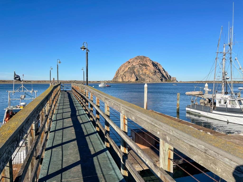 View of Morro Rock from a small pier along the bay waterfront.