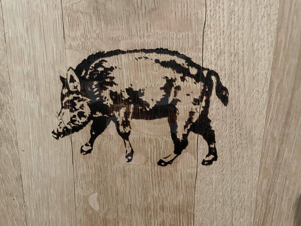 The Eberle logo of a boar stamped on a barrel of wine.
