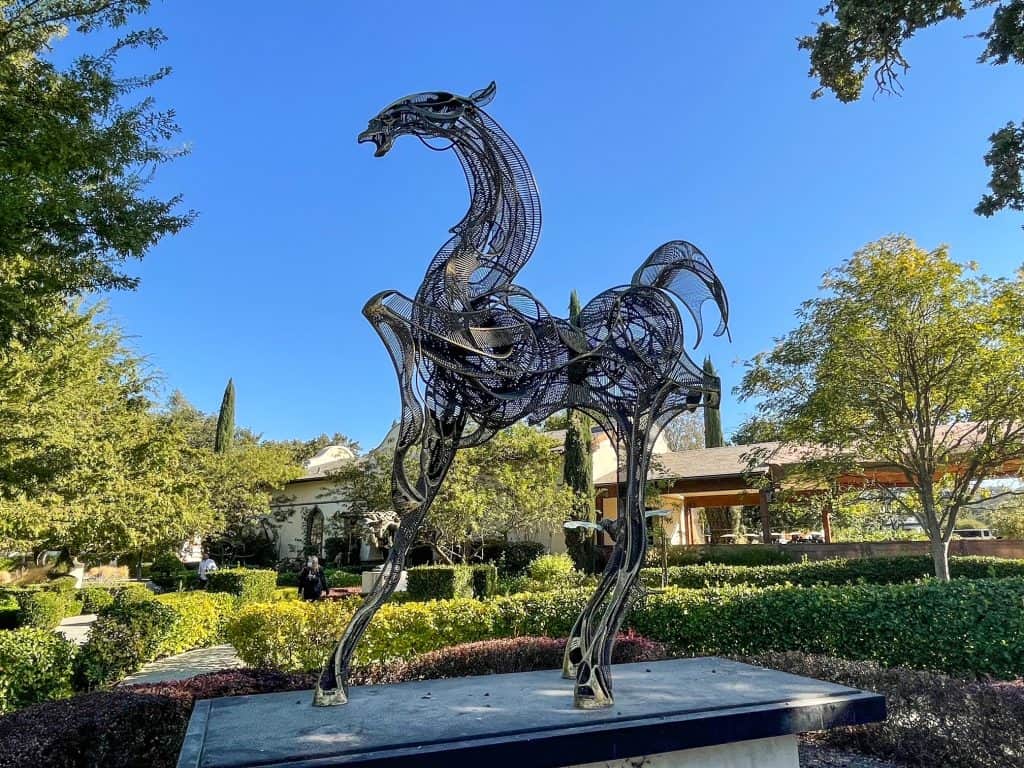 An abstract metal sculpture of a horse in the sculpture garden.
