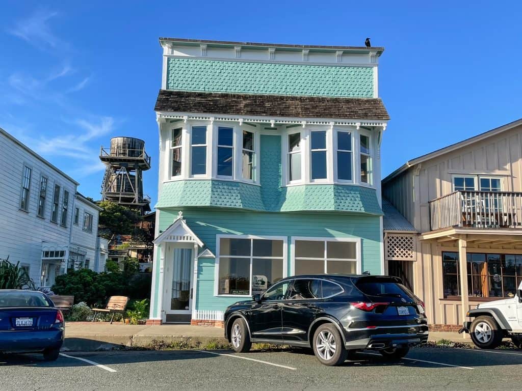 A beautiful pale turquoise Victorian style building along Main Street in Mendocino.