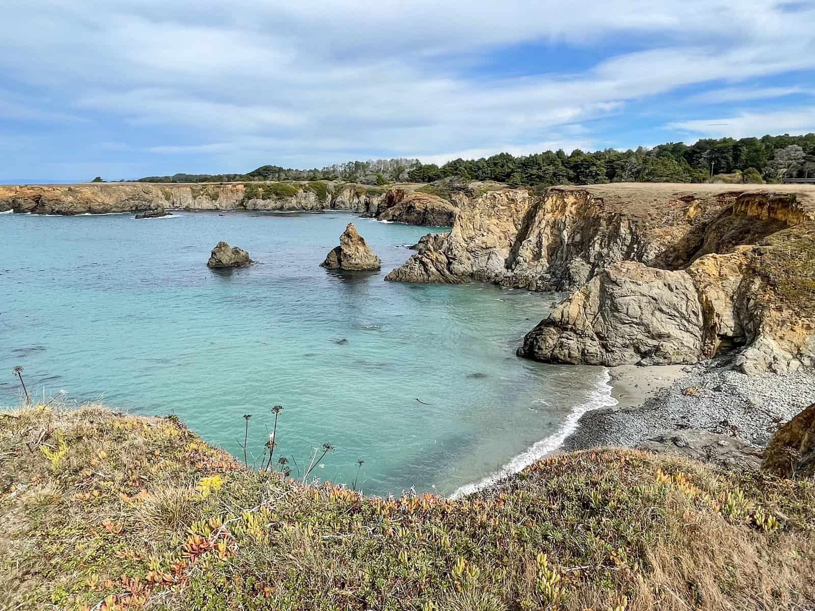 A gorgeous cove along the Pacific Coast with turquoise water, bluffs and rock formations in Mendocino County.