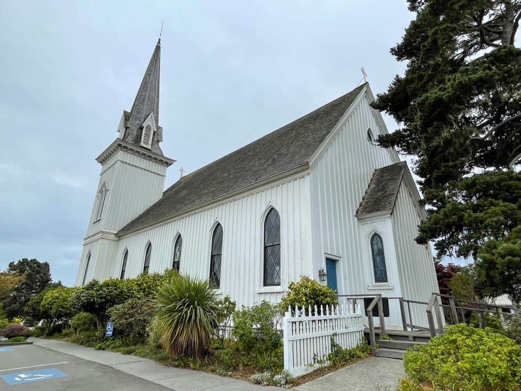 The pretty white Mendocino Presbyterian Church with a slim steeple.