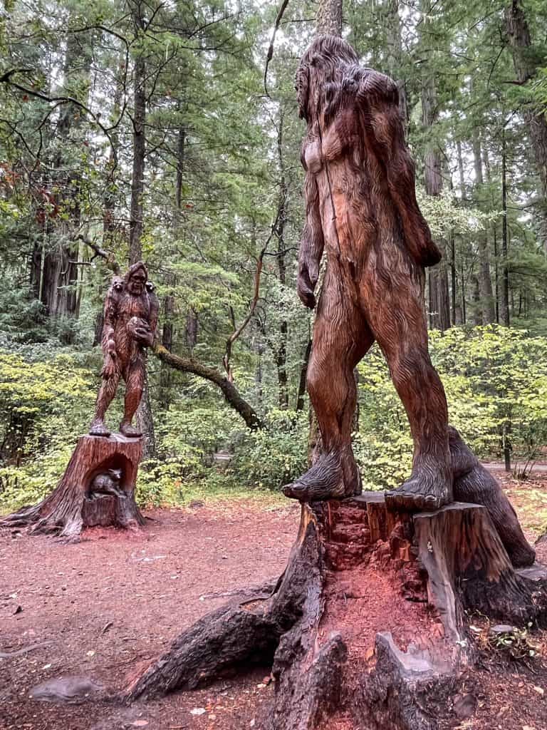 Wood carvings of two separate Bigfoot characters.