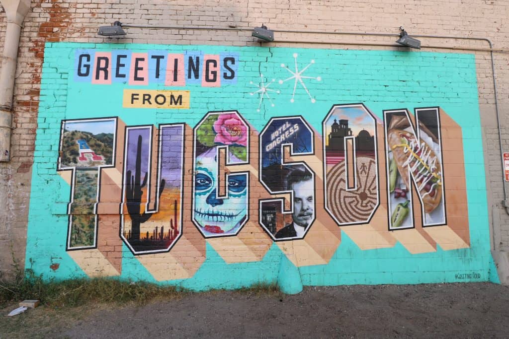 A colorful art mural that says Greetings from Tucson is one of many things to do in Tucson and one way to spend a day in Tucson!