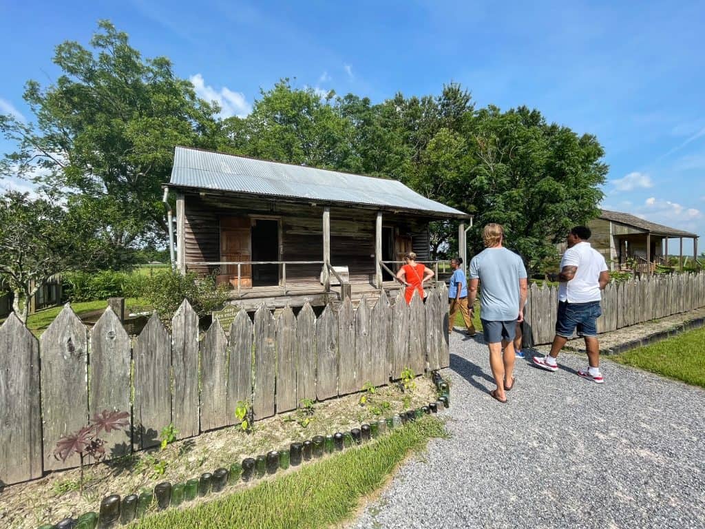 The group tour walking up into a slave cabin at Laura Plantation.