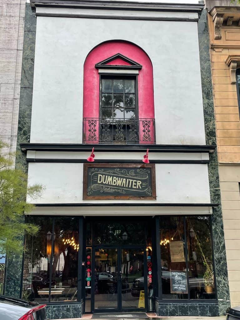 A charming building with bright red and black touches for the restaurant Dumbwaiter on Dauphin Street in Mobile.