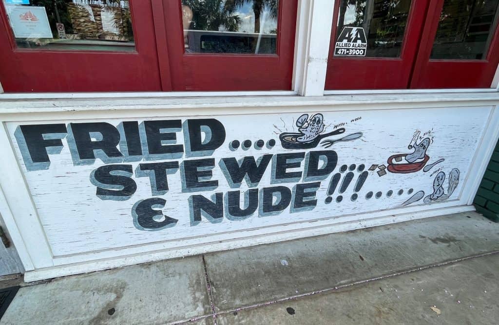 A sign that says "fried, stewed, & nude!" at Wintzell's Oyster House in Mobile.