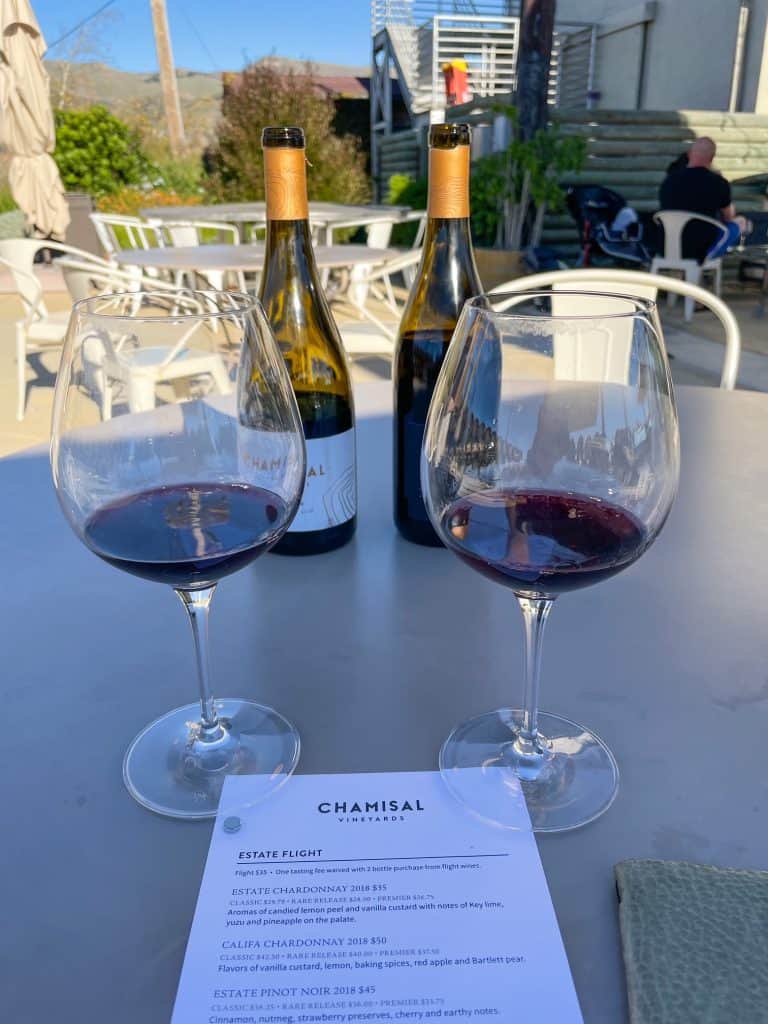 Two glasses of different Pinot Noir on a table at Chamisal Vineyards in Edna Valley, CA.