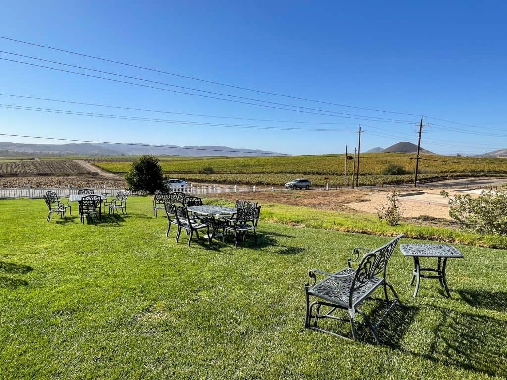 Chairs on the lawn to sit and enjoy wine and the views of Edna Valley from Baileyana in San Luis Obispo, CA.
