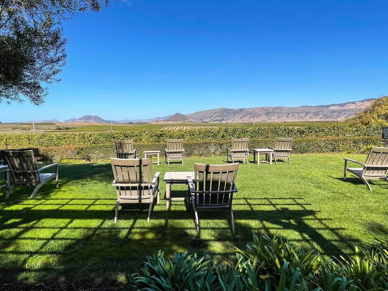 Chairs on the grass at a winery in San Luis Obispo and Edna Valley beyond.