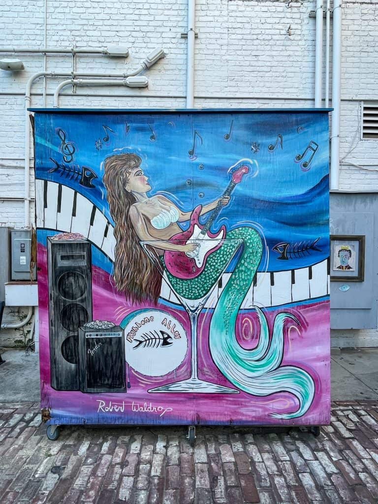 A fun art mural of a mermaid playing a guitar in Gulfport, Mississippi.