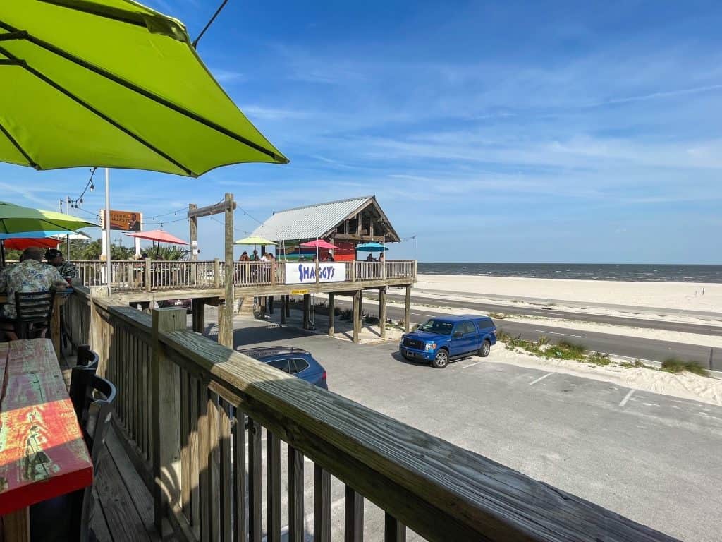 Sitting on the elevated deck at Shaggy's looking out at the beach and ocean at Gulfport Beach.
