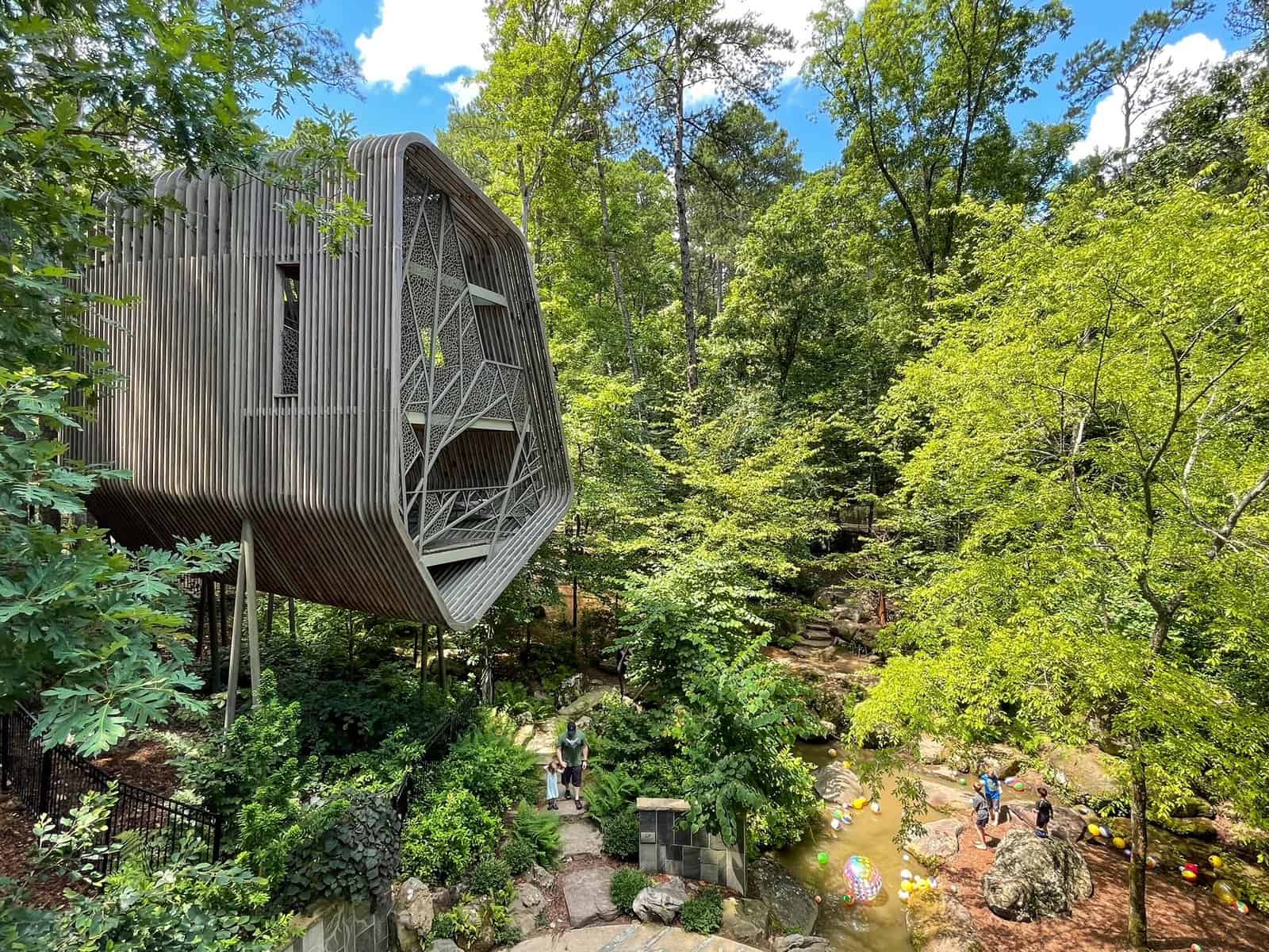 The Evans Tree House surrounding by a lush forest and creek below in Hot Springs, Arkansas.