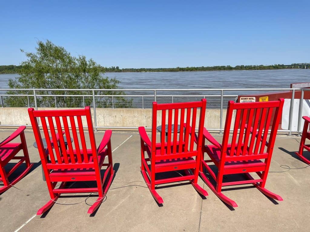 Three rocking chairs along the waterfront looking out at the Mississippi River in Memphis.