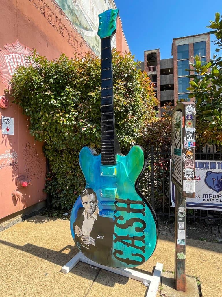 A painted Gibson guitar sculpture with Johnny Cash on it on Beale Street in Memphis.