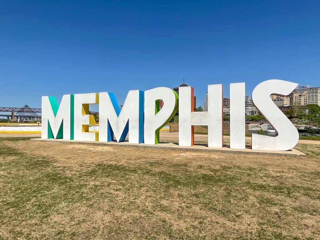 The huge white letters lined in different colors spelling out MEMPHIS on Mud Island and the city skyline behind it across the river.