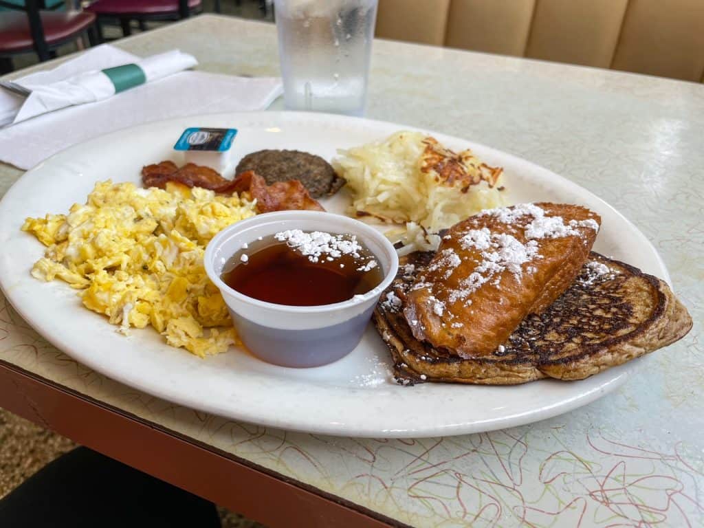 Enjoying a plate with eggs, bacon, a sweet potato pancake and fried french toast at the Arcade Restaurant in Memphis.