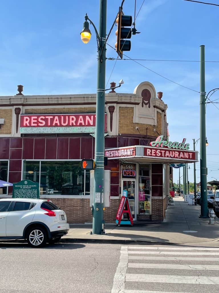 The front of The Arcade Restaurant with its vintage architecture and neon signs.
