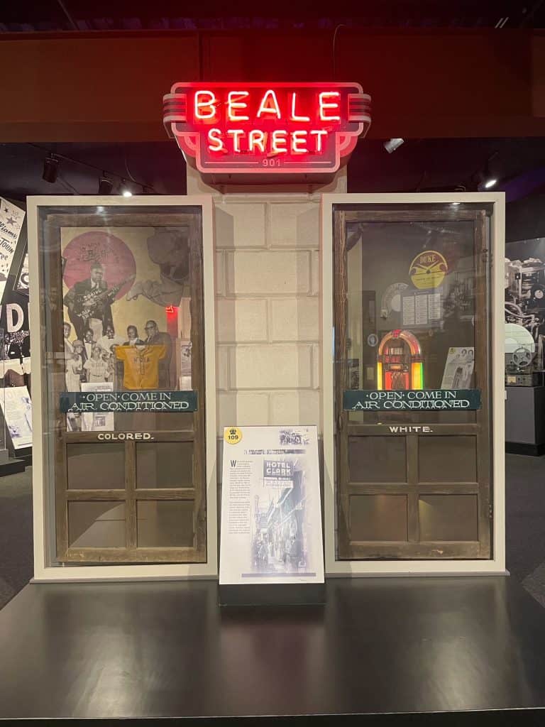 Two screen doors a few feet apart, one for colored people and one for white people with words Beale Street over the top at the Memphis Rock n Soul Museum.