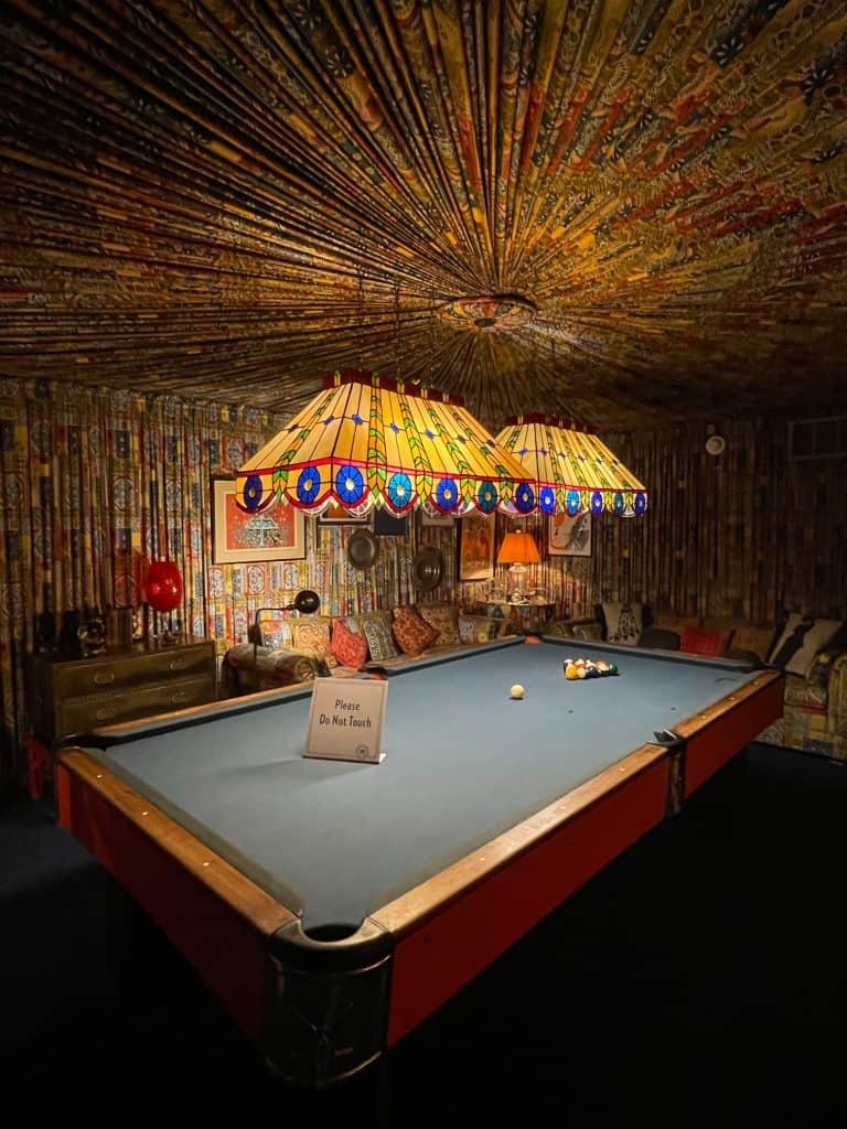 The billiard room at Elvis Presley's mansion with pleated fabric with a yellow and multi-colored print on the walls and ceiling is a jaw-dropper to see at the mansion, part of Graceland in Memphis.
