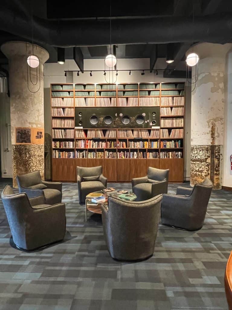 Comfy chairs surrounded with a library of records for listening to in the Music Lab within Crosstown Concourse in Memphis.