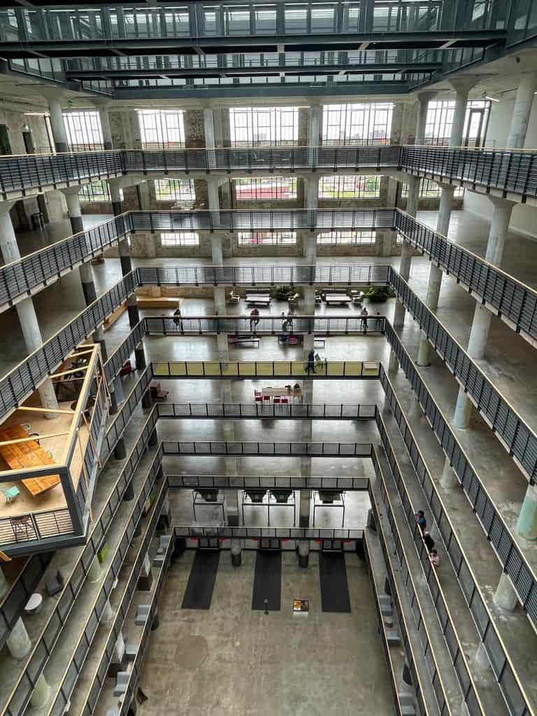 Standing up at the top floor looking down to the bottom with the buildings open layout of the Crosstown Concourse building.