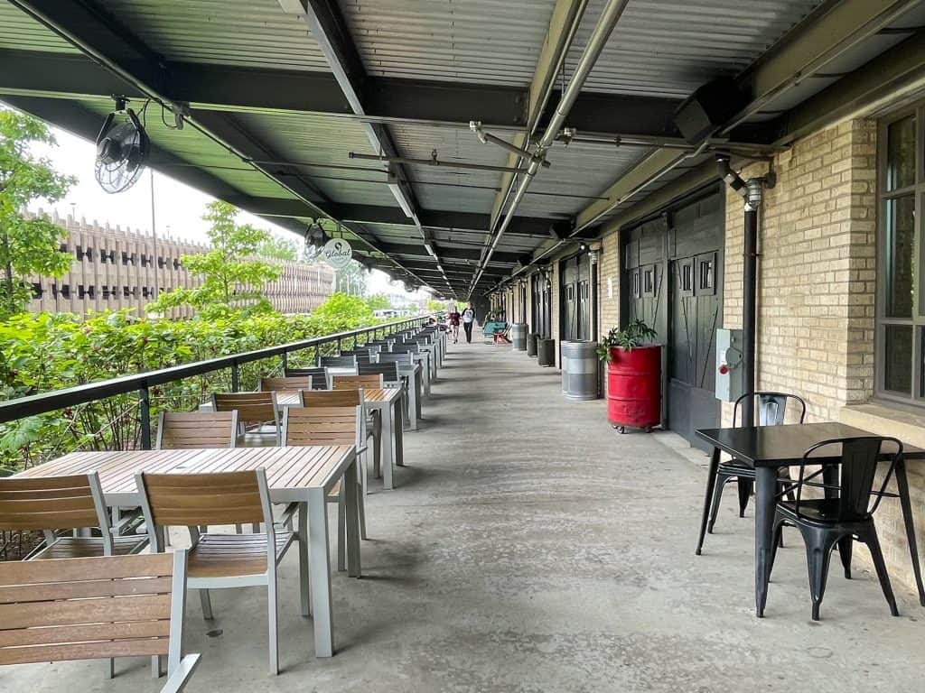 Outdoor patio seating along the length of the building and in front of several different eateries at the Crosstown Concourse in Memphis.