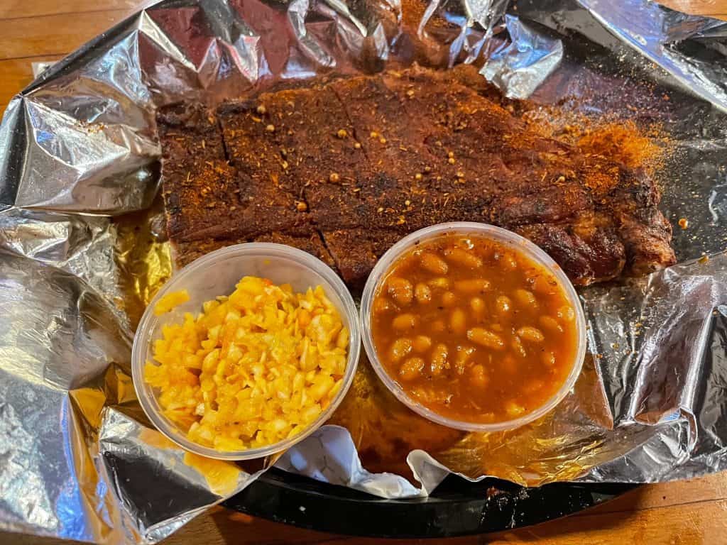 A small rack of pork ribs, coleslaw, and baked beans in Memphis.