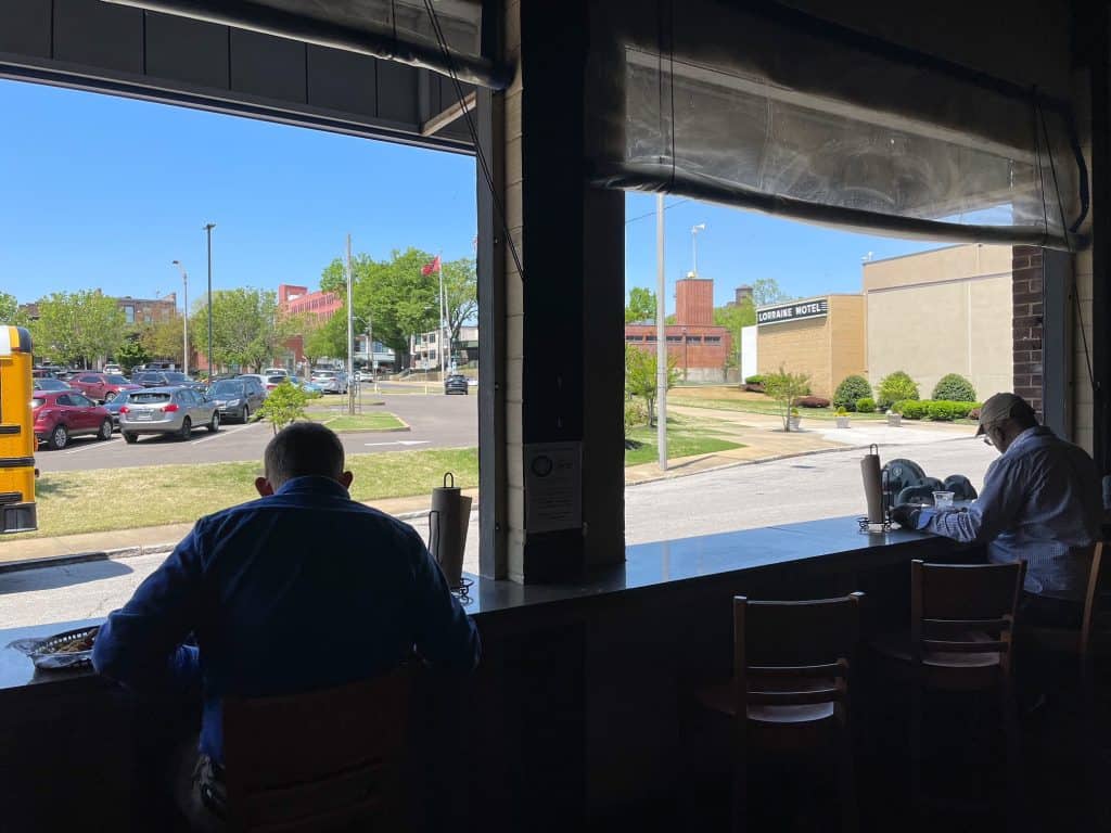 Sitting at the bar facing open out onto the street with a view of the Lorraine Motel from Central BBQ in Memphis, Tennessee.