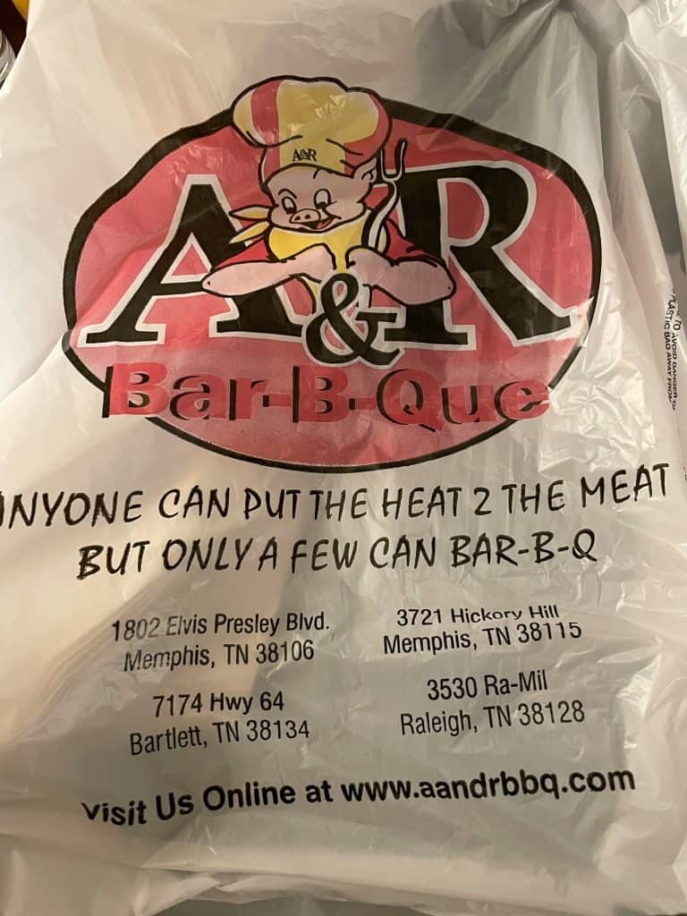 A bag from A&R Bar-B-Que with their logo on it and says " anyone can add heat to meat but only a few can Bar-B-Q.