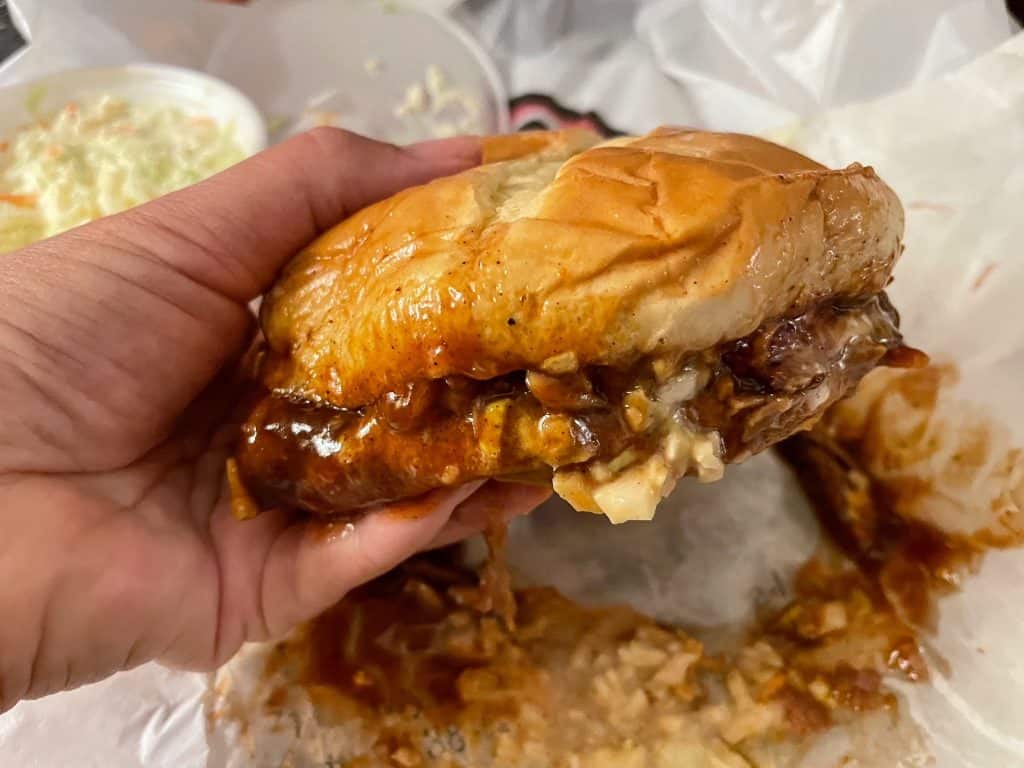 A pulled pork sandwich with coleslaw and BBQ sauce on it from A&R Bar-B-Que restaurant in Memphis, TN.