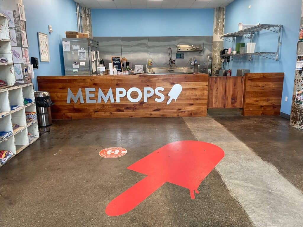 A huge red popsicle painted on the floor inside MEMPOPs popsicle shop in Crosstown.