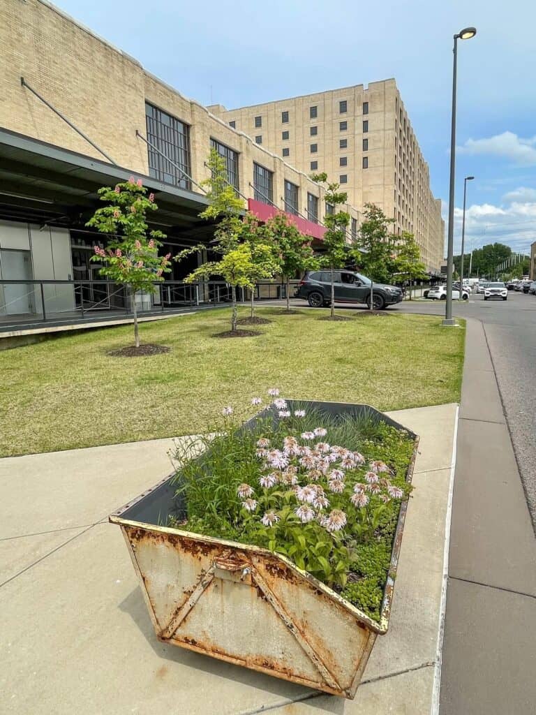 Side view of the old Sears building now the Crosstown Concourse with a flower planter in front in Memphis.