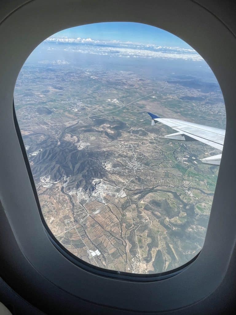 View of Mexico from the plane window as flying is one of the tips for traveling to Mexico 