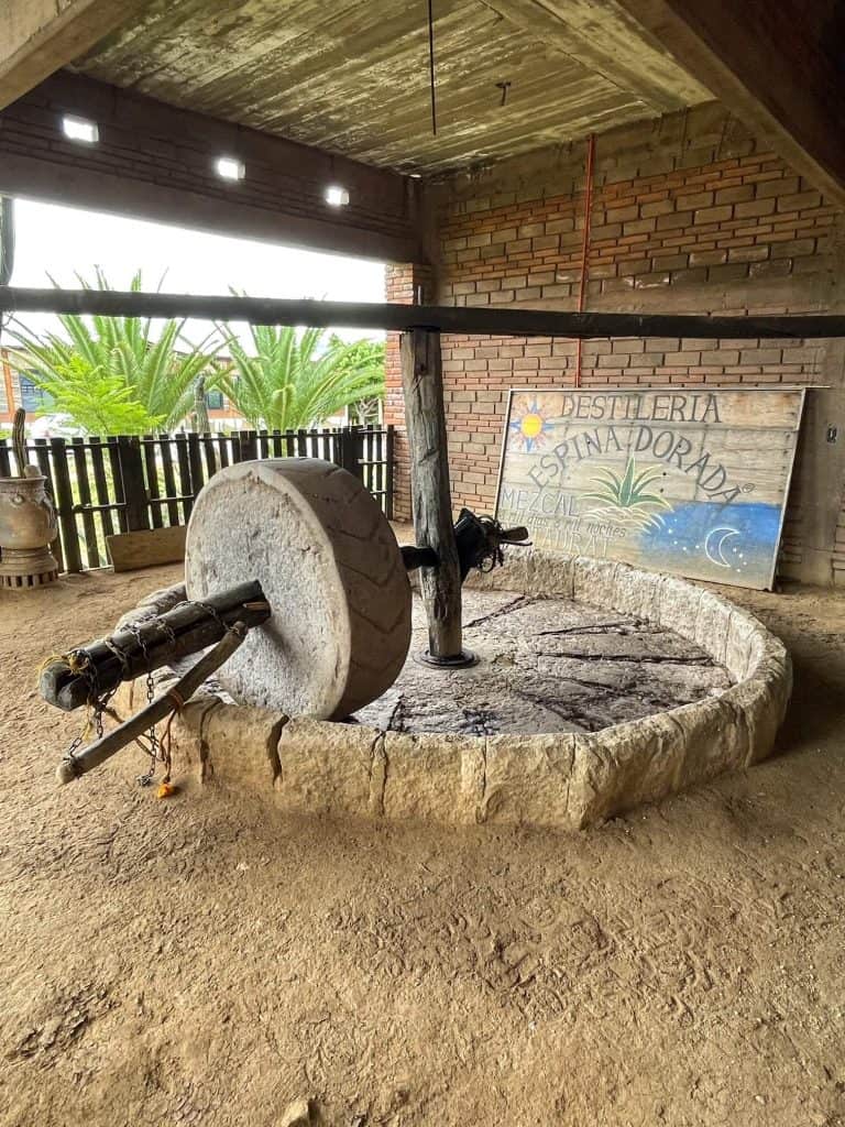Large stone grinder for the roasted agave plant in making mezcal in Oaxaca.