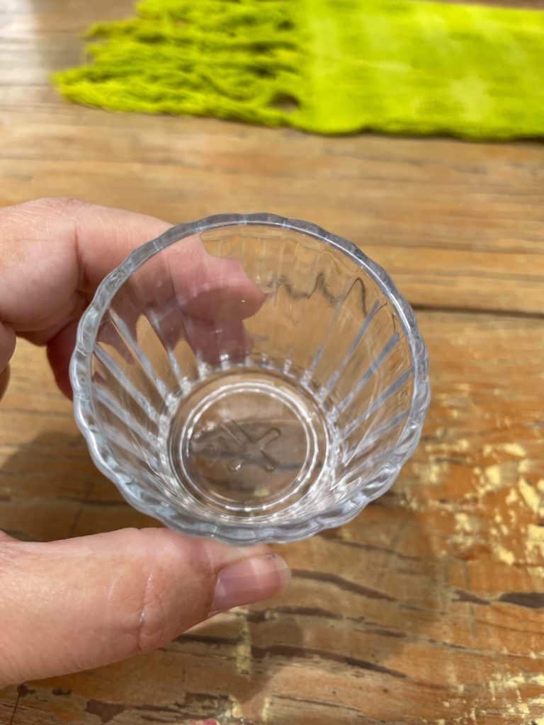 Sipping clear mezcal in a shot glass at a palenque in Oaxaca, Mexico.