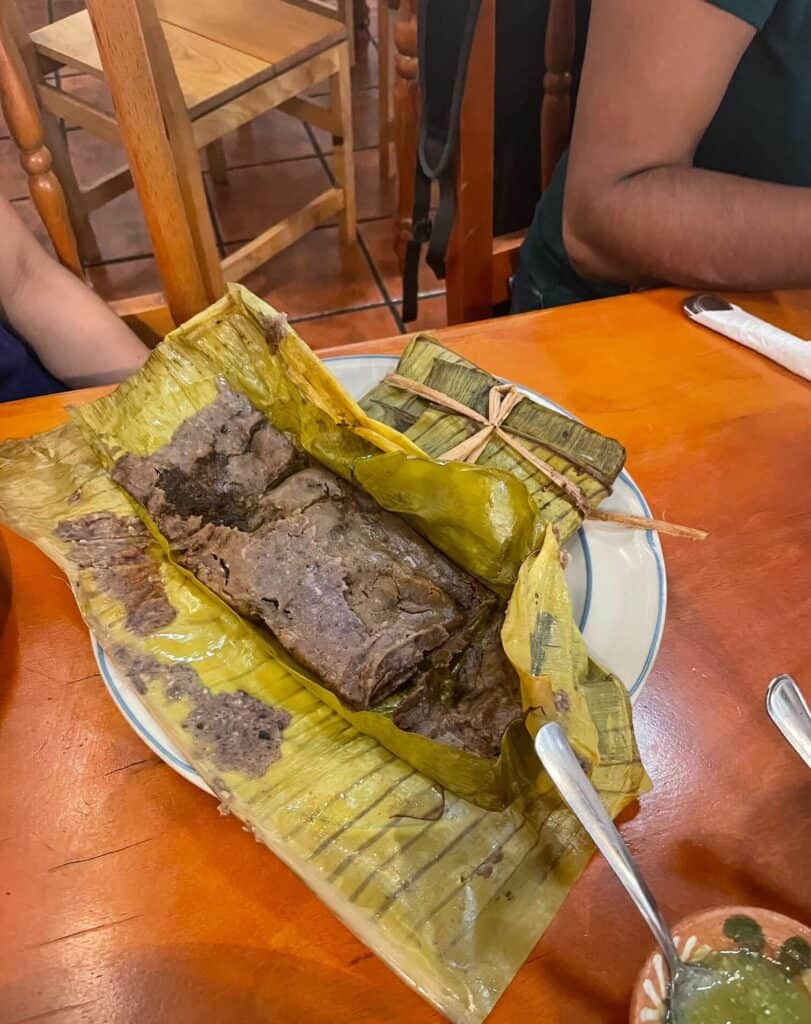 Tamales Oaxaquenos wrapped in a banana leaf and made with blue corn at a restaurant in Oaxaca, Mexico.