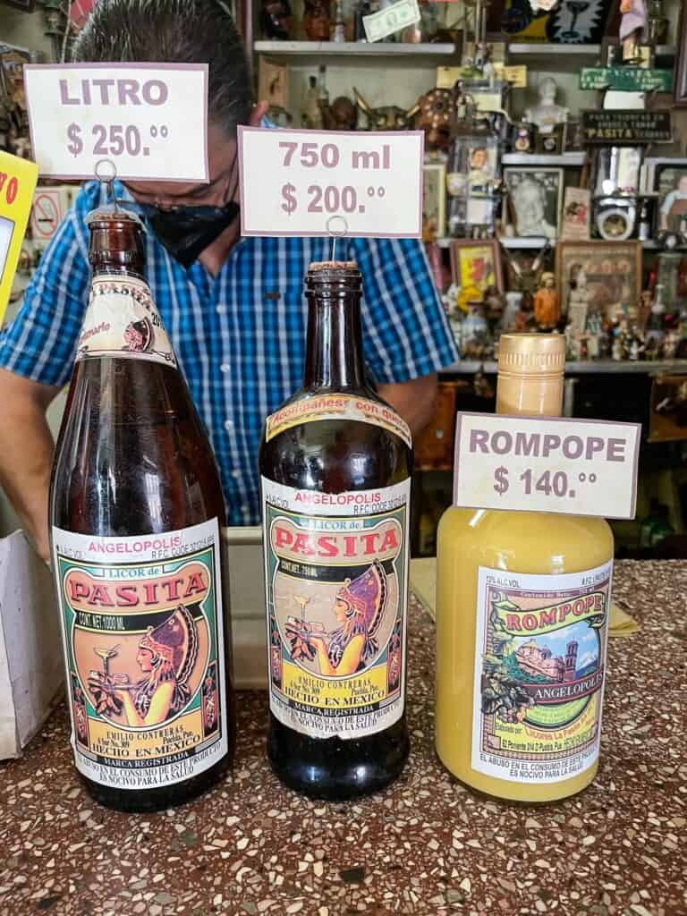 Three different sized bottles of Pasita that you can buy to take home at La Pasita in downtown Puebla City.