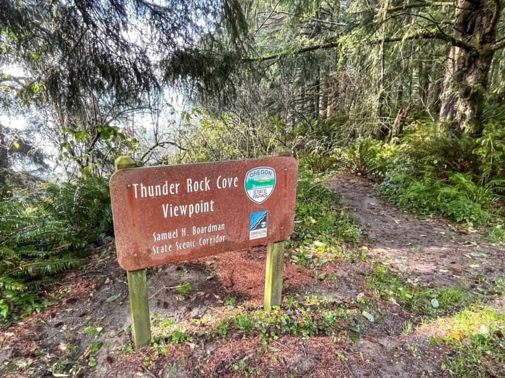 Sign that says Thunder Rock Cove Viewpoint and a trail leading off through dense forest.