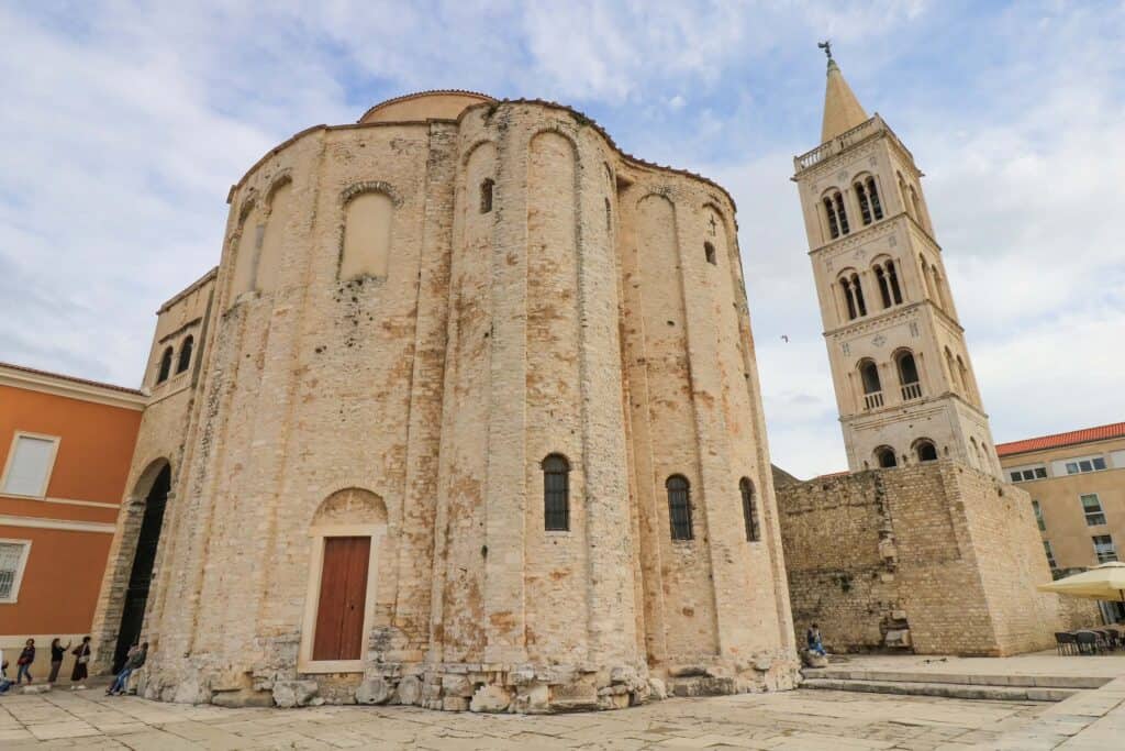 A huge cylindrical cathedral and bell tower, part of the Roman ruins in Zadar, Croatia.