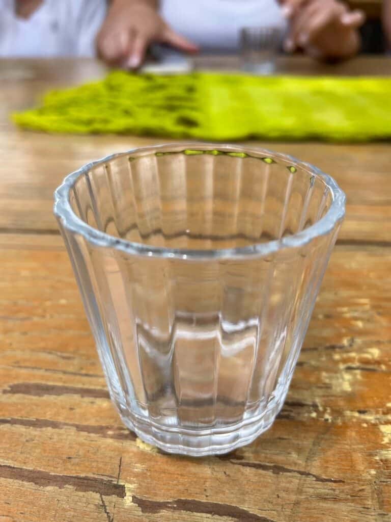 A small shot glass on a table during a mezcal tasting at a distillery in Oaxaca.