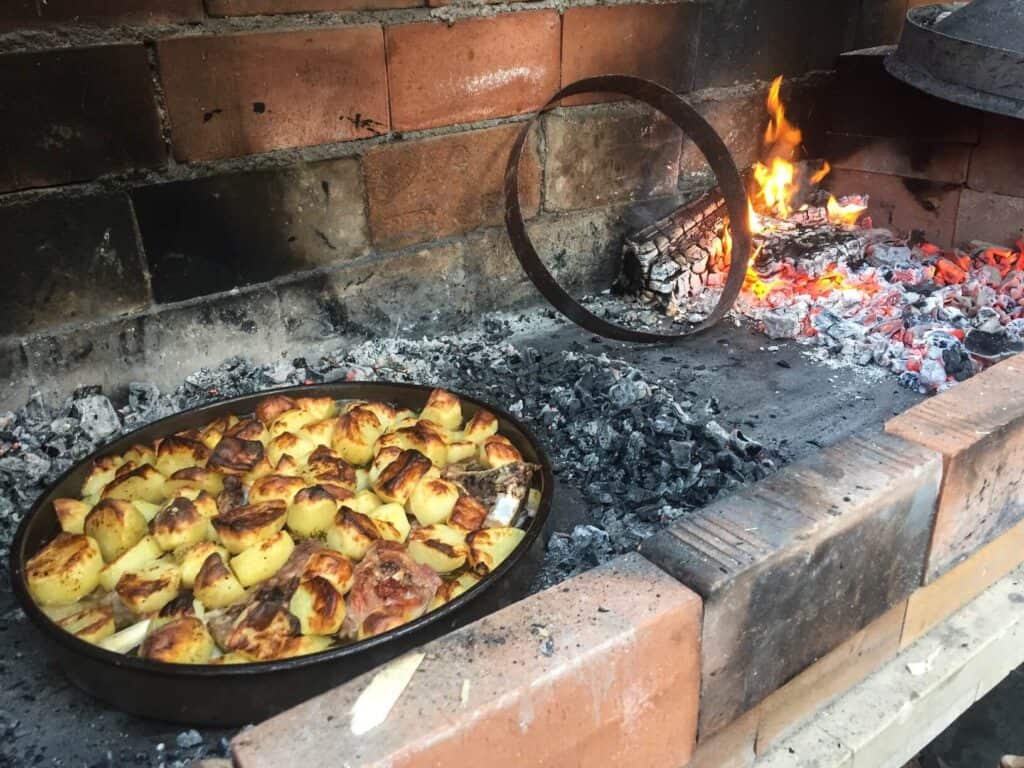 A large pan of peka, a local Croatian dish cooking over hot coals for hours.