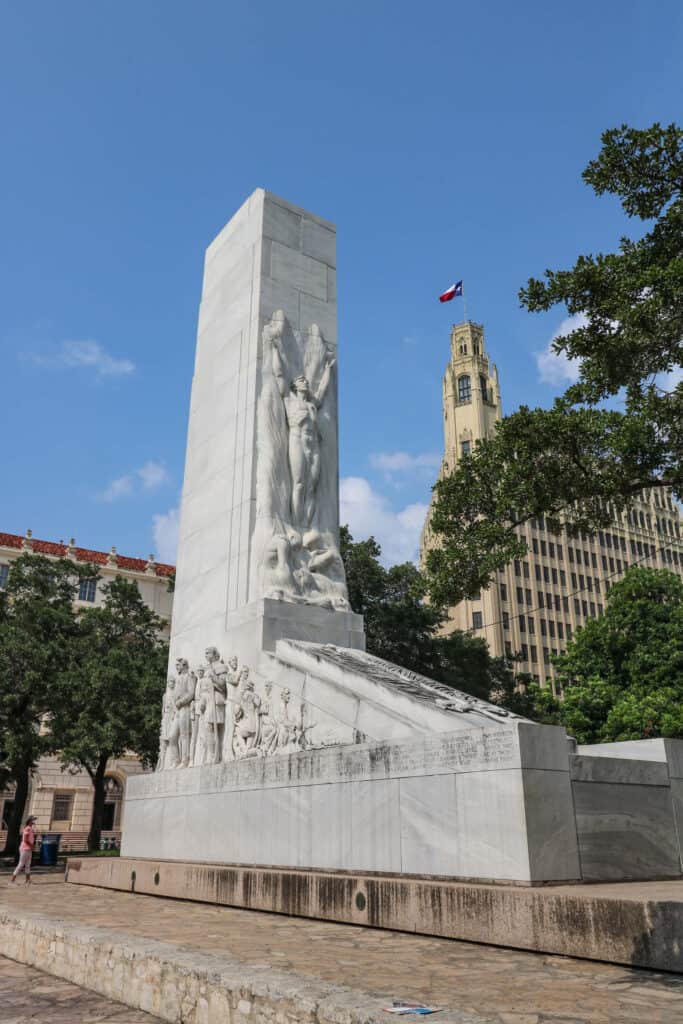 The tall white colume of the Alamo Centotaph monument in front of the Alamo to remember the Battle of the Alamo in San Antonio.