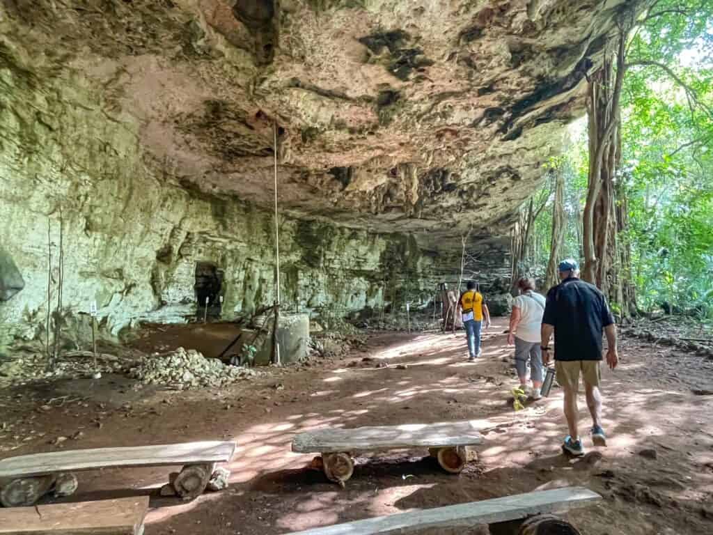 Walking in the dry cenote where many bees have natural hives at Xkopek Bee Keeping Park.