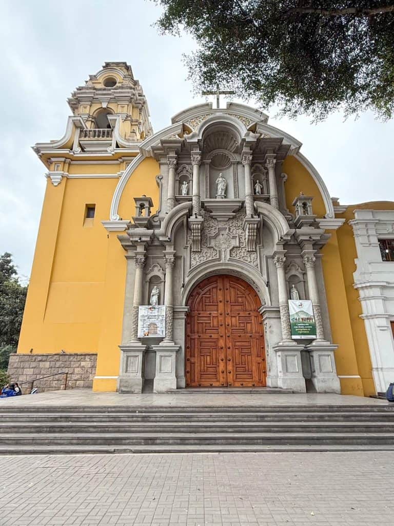 A colonial style church in yellow color along Municipal Park in Barranco, Lima.