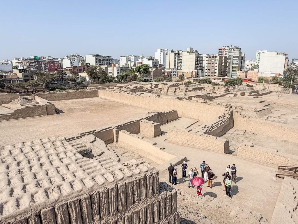 Standing on top of the pyramid at Huaca Pucllana ruins looking down at the various excavated ruins and the modern city of Lima surrounding it.
